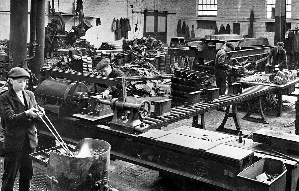 Photo of Assembling and Riveting Buffer Trimmers on Machine made at Wolverton. Gravity conveyor by British Mathews Limited. London, E.C.