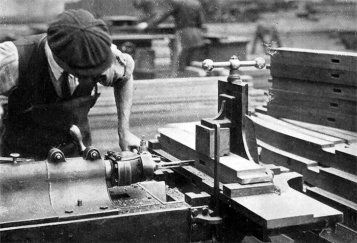 Photo of Mortising Coach Timbers on Horizontal Machine by means of Jig and Mortise Registering Device.